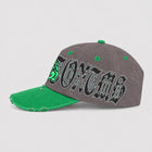 Opposite side view of ANTOXTMS tan and brown cap with gothic lettering